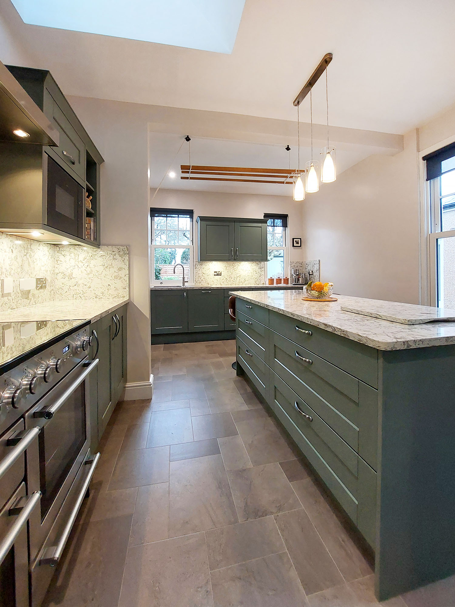 green shaker kitchen with pale olive green splashback